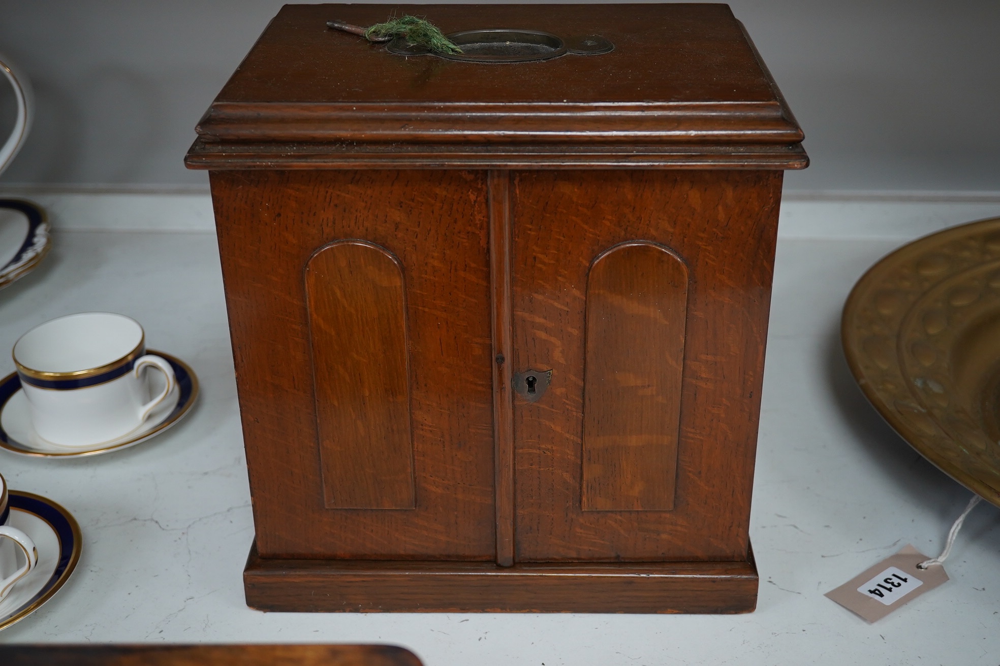 A Victorian oak two door, four drawer, vertu cabinet, with brass drawer military style handles and walnut timepiece, 29cm high, 28cm wide. Condition - fair to good